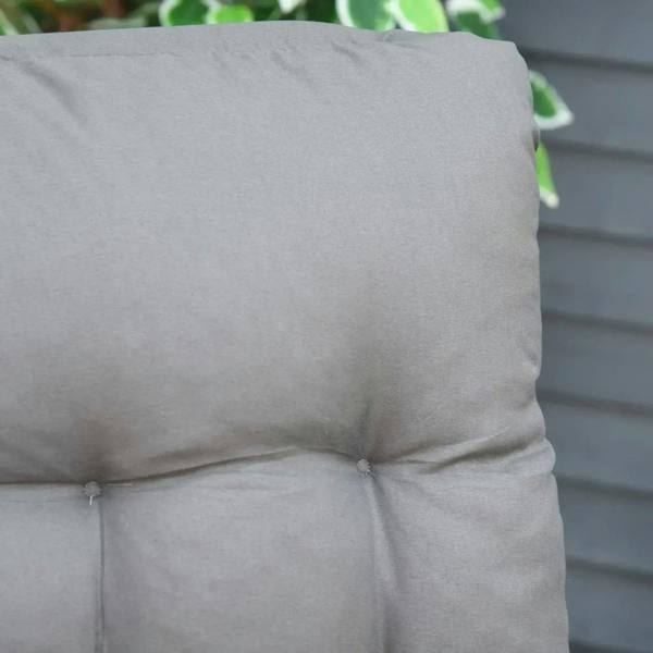 Grey padded cushion with stitched tufted panels and corner tie points