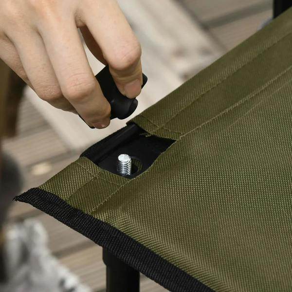 Close-up of strap fastening on green fabric panel with metal grommet on trolley