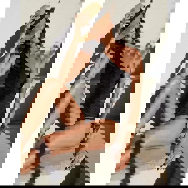 Black Miraclesuit Network Jena swimsuit with straw hat and bracelet