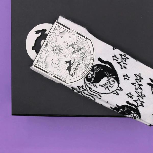 White bamboo crew sock with black cat faces, stars, and striped details