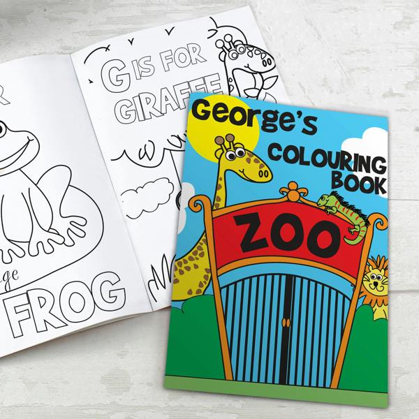An open personalised zoo colouring book showing a frog and giraffe page alongside the bright blue and red front cover customised with the name George's.