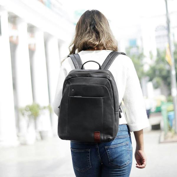 Person wearing a black backpack outdoors