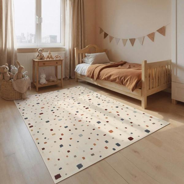Children's bedroom with a polka dot rug, wooden bed, and toys.