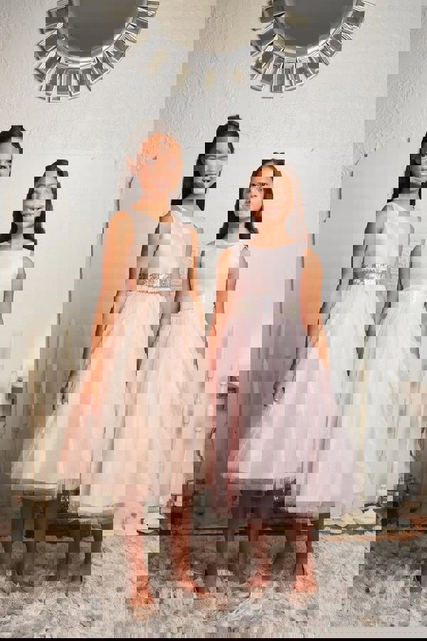 2 dresses in blush and baby pink worn together