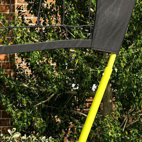 Folded portable net frame with lime pole and black fabric panel attached near patio railing