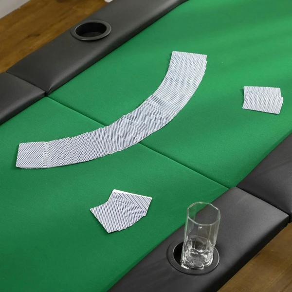 Green felt poker table corner with cup-holder opening and padded black edge with seams
