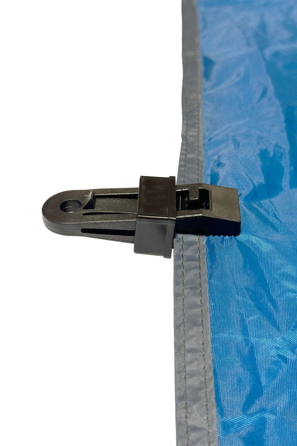 Illustration of a OLPRO Tent Groundsheet Pegging Clamp attached to a tent canvas, demonstrating one of its numerous applications. Available in a pack of four.