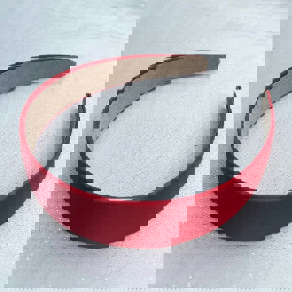 Red hairband, smooth satin finish, slim padded design, vibrant red colour, classic everyday accessory, minimalist headband style
