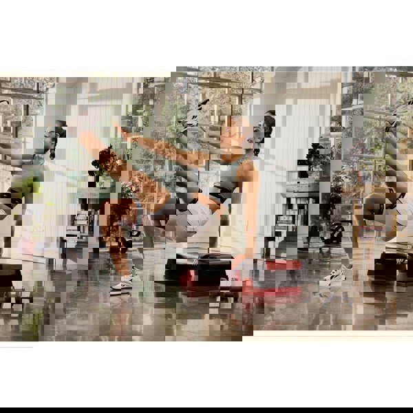 Woman performing Reebok Step Fitness Training home workout- Red