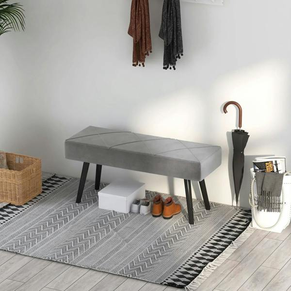 Grey upholstered bench with padded rectangular seat and dark steel legs