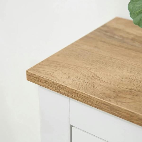 Wood cabinet top corner on a white shoe storage cabinet with clean edges