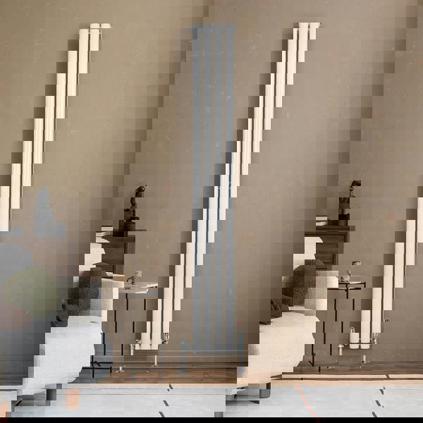 Sleek white oval single column radiator, 1800 x 240mm, mounted on a textured wall, complementing modern living room decor