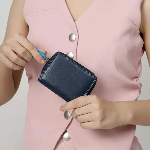person holding blue small soft leather purse katie london