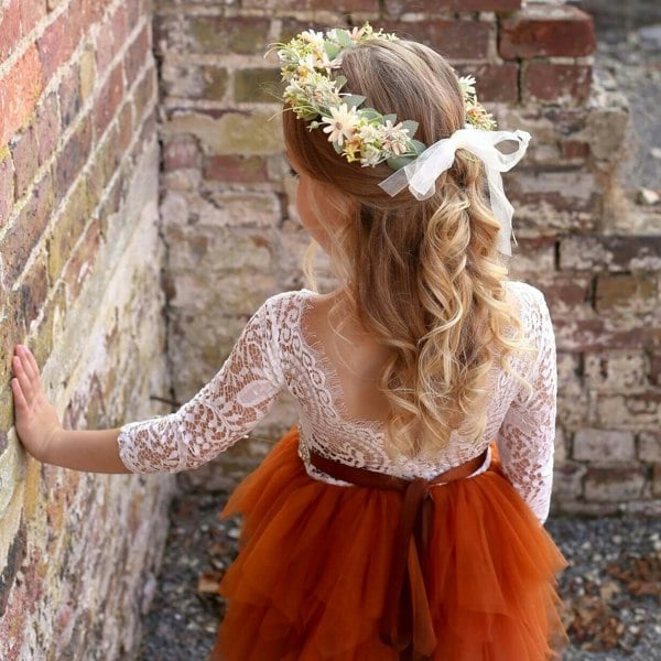 Child wearing garland and dress