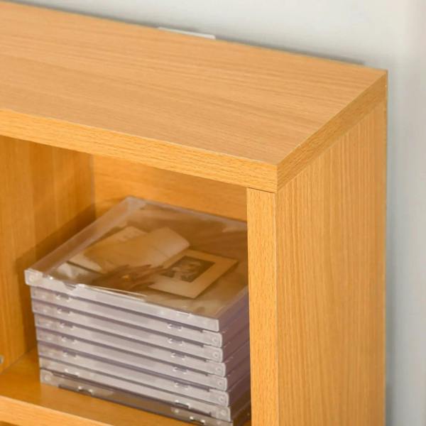 Beech wood CD storage cabinet corner with stacked disc cases inside