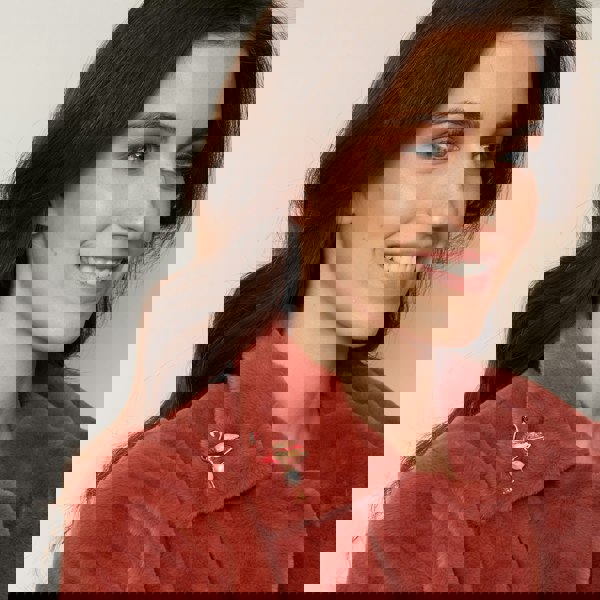 flamingo brooch in pink with pearl worn on coat