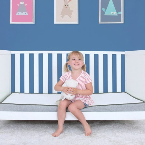 Girl sat on cot bed