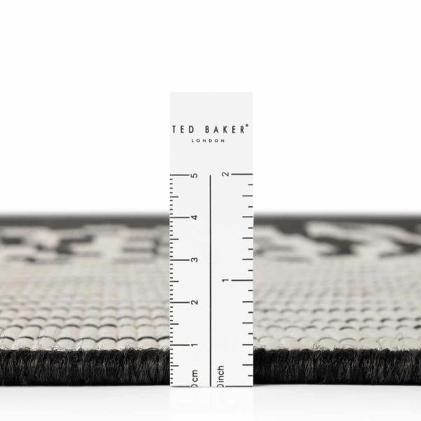Black and white patterned rug with a ruler for scale and 'Ted Baker' branding.