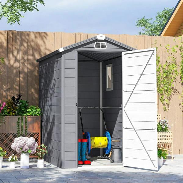 Grey plastic wall shed with open door and side window, holding garden tools
