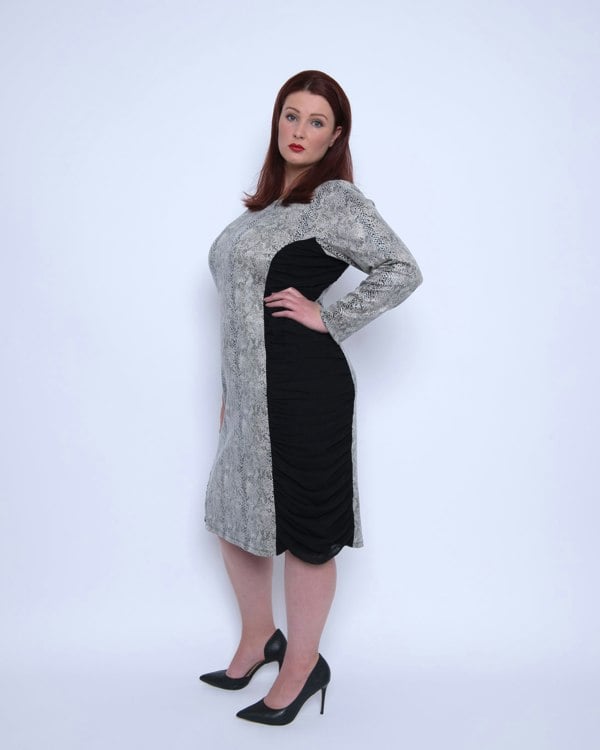 Women's Plus Size Black White Animal Print Bodycon Midi Vegan Leather Dress shown from the side, styled with black heels for a chic look.