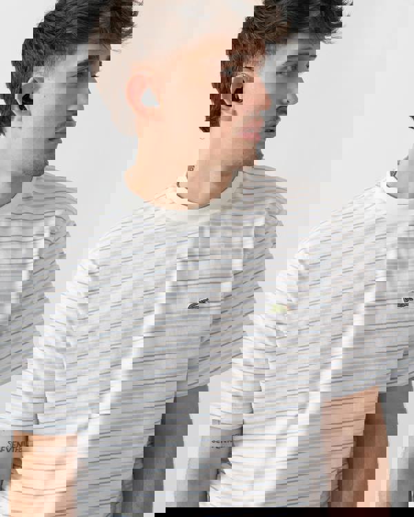 close up shot of a model wearing Lacoste Stripe Mens Classic Fit T-Shirt in Phoenix Blue-Flour