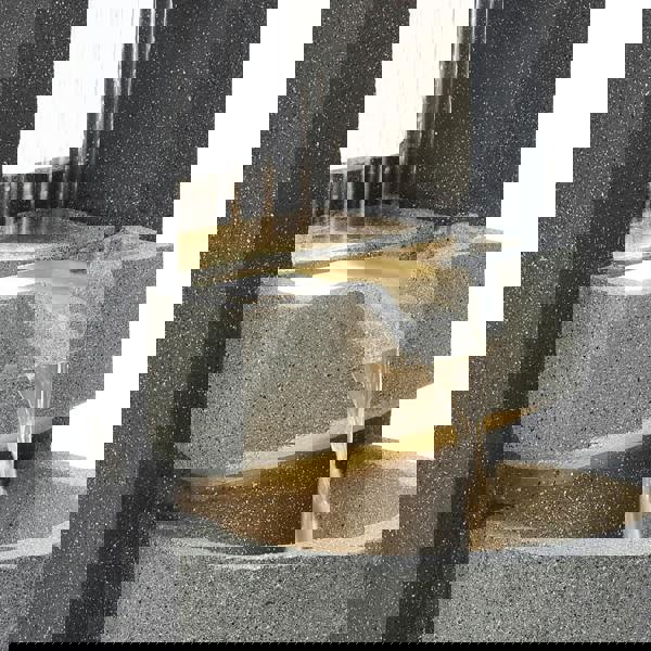 Sleek electric water feature with cascading water flow, textured gray stone finish, and illuminated basin for a tranquil ambiance