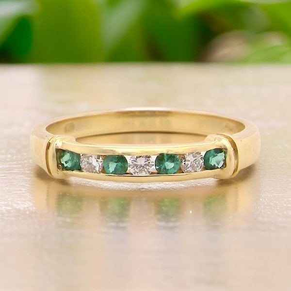 Vintage Tom An 18 carat gold Emerald and Diamond Eternity ring