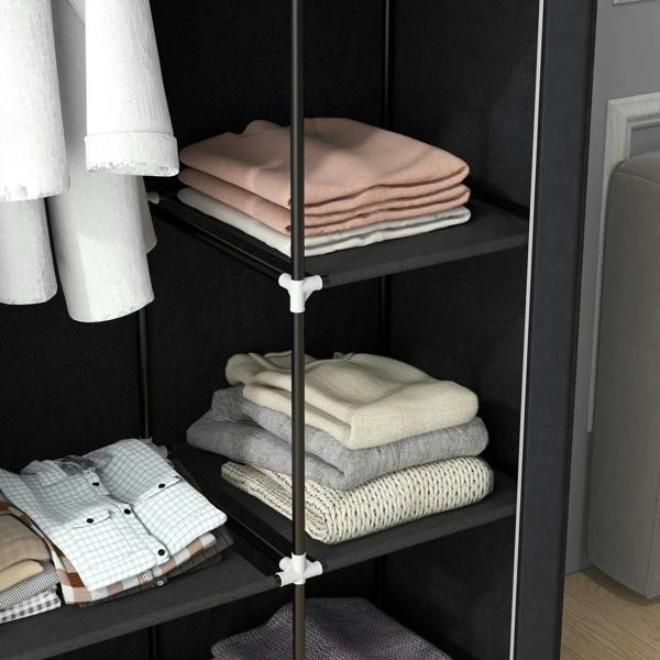 Black wardrobe shelves with folded shirts and blankets stacked neatly.