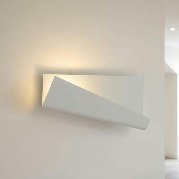 White modern wall sconce indoor on a cream background in a hallway