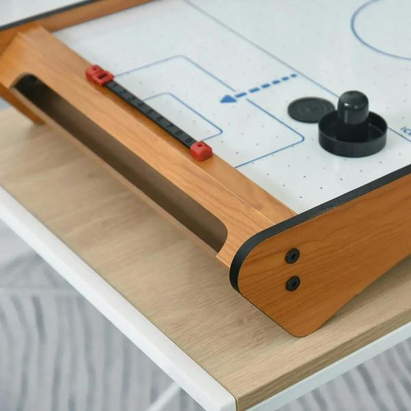 Close-up of wooden tabletop air hockey table corner with red goal pucks