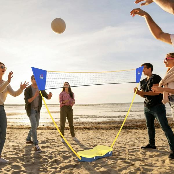 Outdoor portable badminton net set with yellow frame and blue corner flags on sand