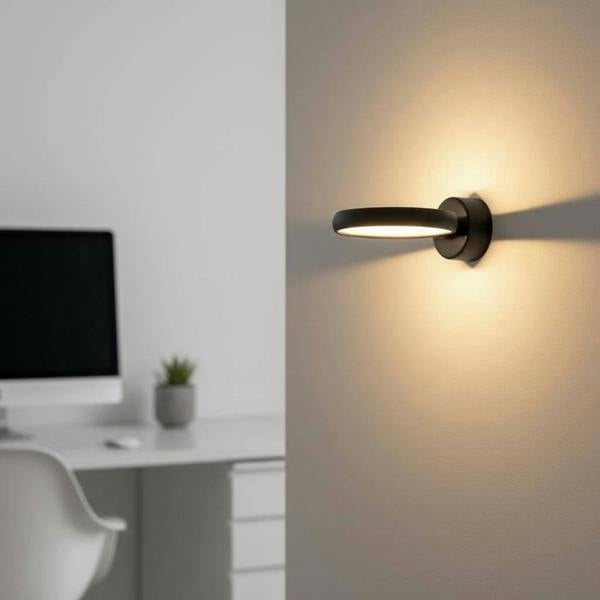 Black internal wall light on a grey wall next to a desk in a modern family home