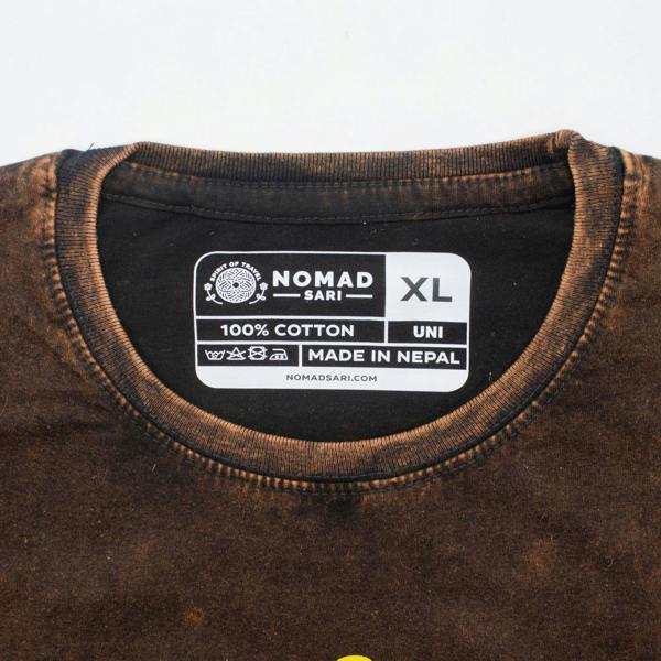 Brown cotton T-shirt neck label marked NOMAD SARI, 100% COTTON, size XL