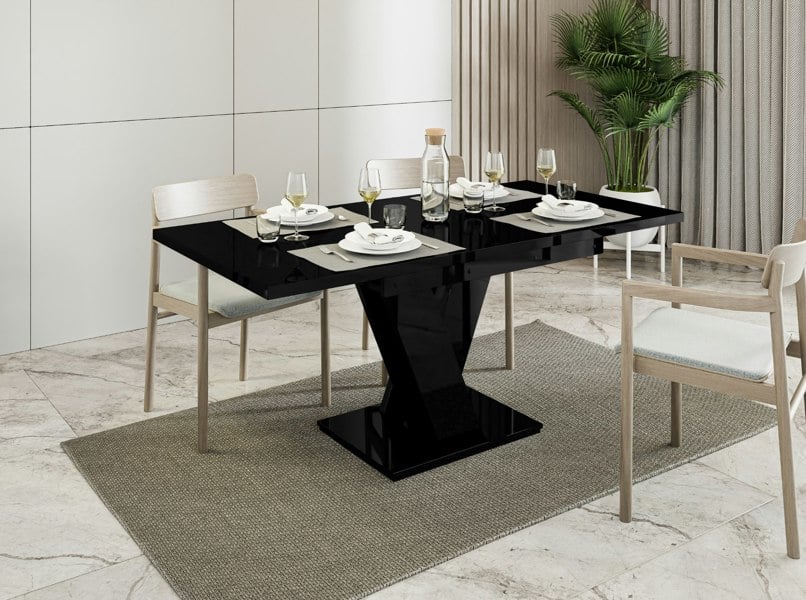 Compact black gloss dinner table MASIV with striking V-shaped stand.
