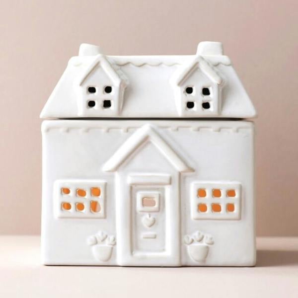 Front view of the white Ceramic House wax melt burner with cottage windows and roof dish on a beige backdrop by Abode Home & Gifts