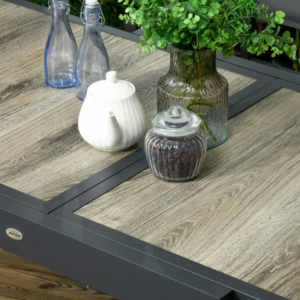 Outdoor dining table tabletop detail with accessories and dark frame support