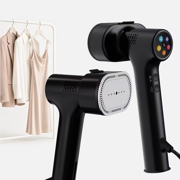 Two black Fridja f20 Handheld Clothes Steamer Pro with Suction devices are featured. One unit highlights a control panel with colored buttons, while the other showcases the ironing plate equipped with multiple small holes. Both garment steamers present a sleek, modern design set against a plain background.