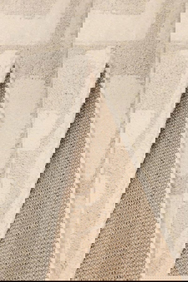 Close-up of the Ava Pave Wave Illusion Rug showcasing its soft cream texture and high-low pile design.