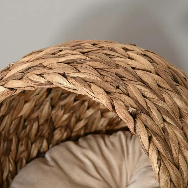 Close-up of rattan wicker weave on a cat bed dome, with light cushion edge visible