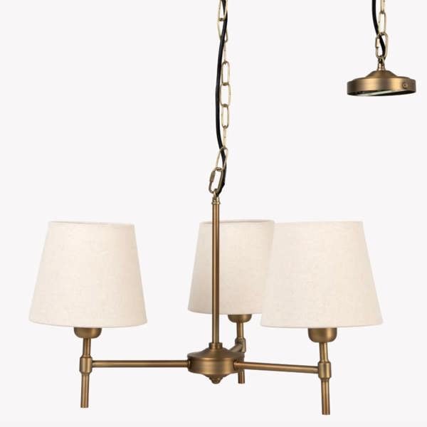 A studio product packshot of the 3-light antique bronze steel chandelier with oatmeal linen shades against a white background by Abode Home & Gifts.