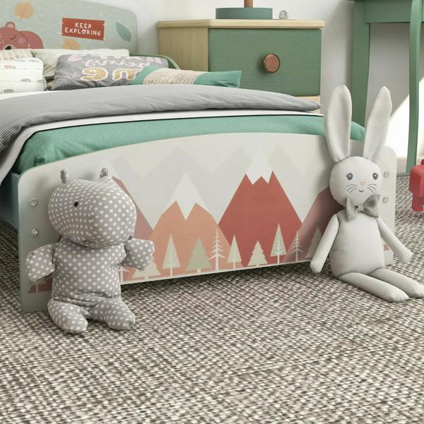 Green toddler bed frame with side safety rails, woodland print end panel, and slatted base