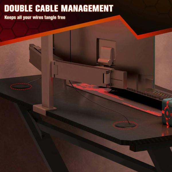Black gaming desk underside showing cable organizer channels under the desktop