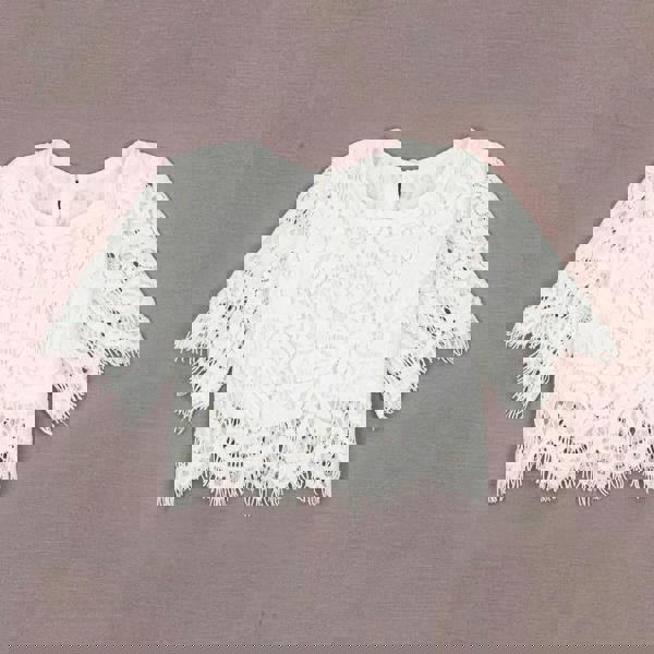 White lace top on a gray background
