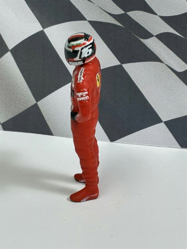 a toy figure of a race car driver