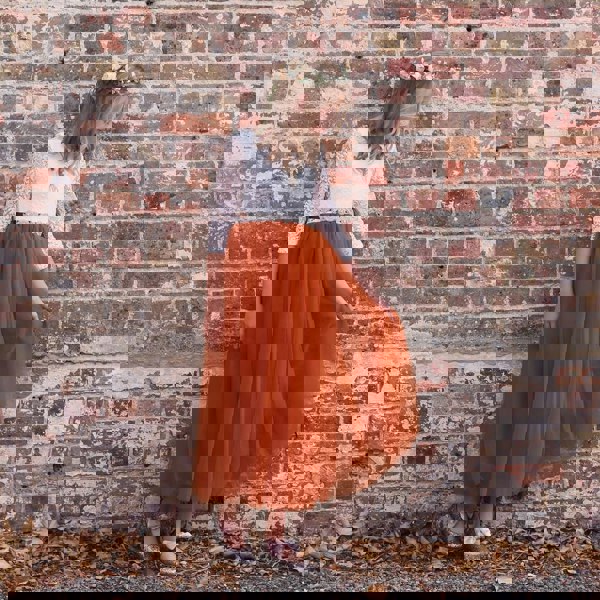 Young flower girl playing with skirt