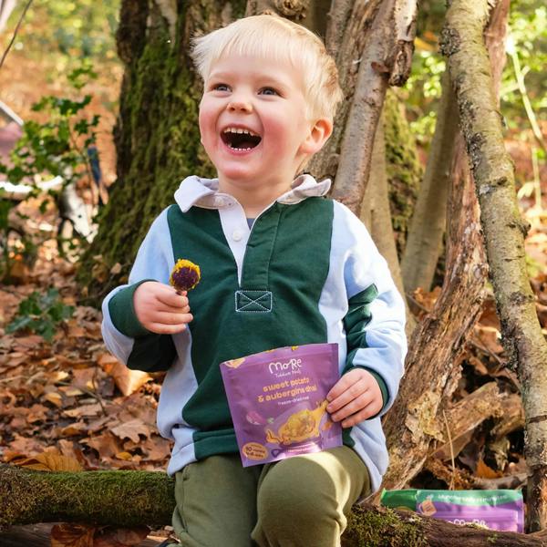 toddler in woods with a more toddler meal for on the go lunch