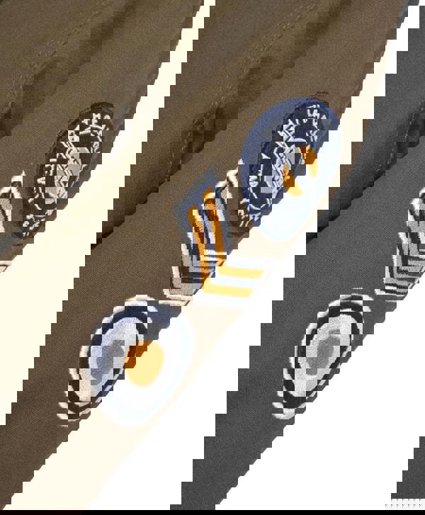 Lambretta Mens/Womens Carnaby Scooter Hooded Classic Mod Ska Badge Parka, close-up of the khaki fabric with detailed embroidered patches including a circular patch, chevron symbols, and target motifs.