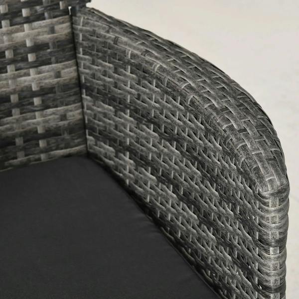 Grey rattan chair armrest and seat cushion edge with woven wicker detail