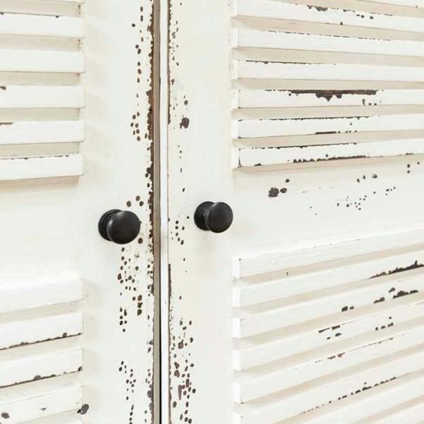 A close-up view of the weathered white wood louvres and dark door knobs on the Château window mirror.
