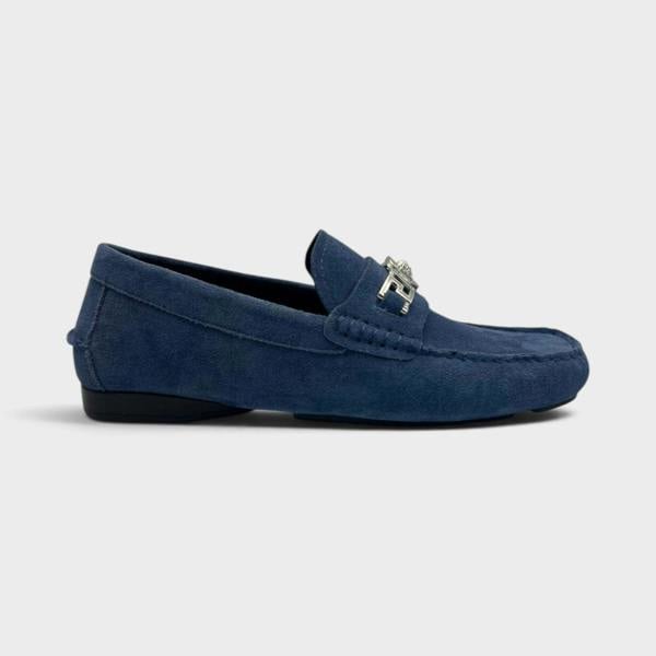 Supplied Fashion navy suede Medusa Greca driver loafer with silver metal hardware detail on a neutral background.
